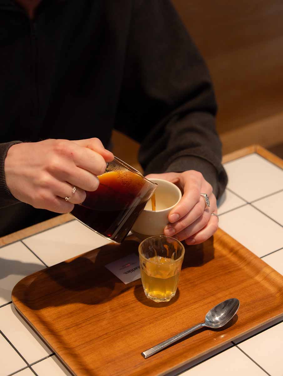 Coffee being poured from Kinto coffee server